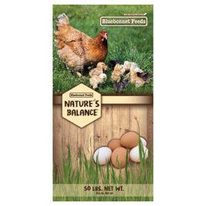 Nature’s Balance Egg Booster Crumbles in bag with grassy nature scene with hen, chicks and eggs